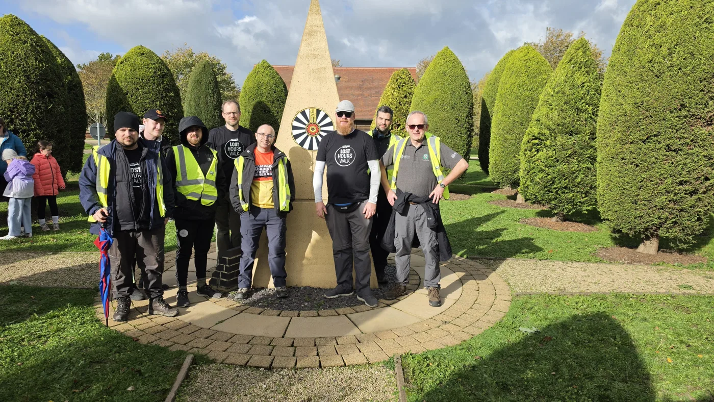 Lost Hours walkers at the Round Table memorial in the grounds at Alrewas